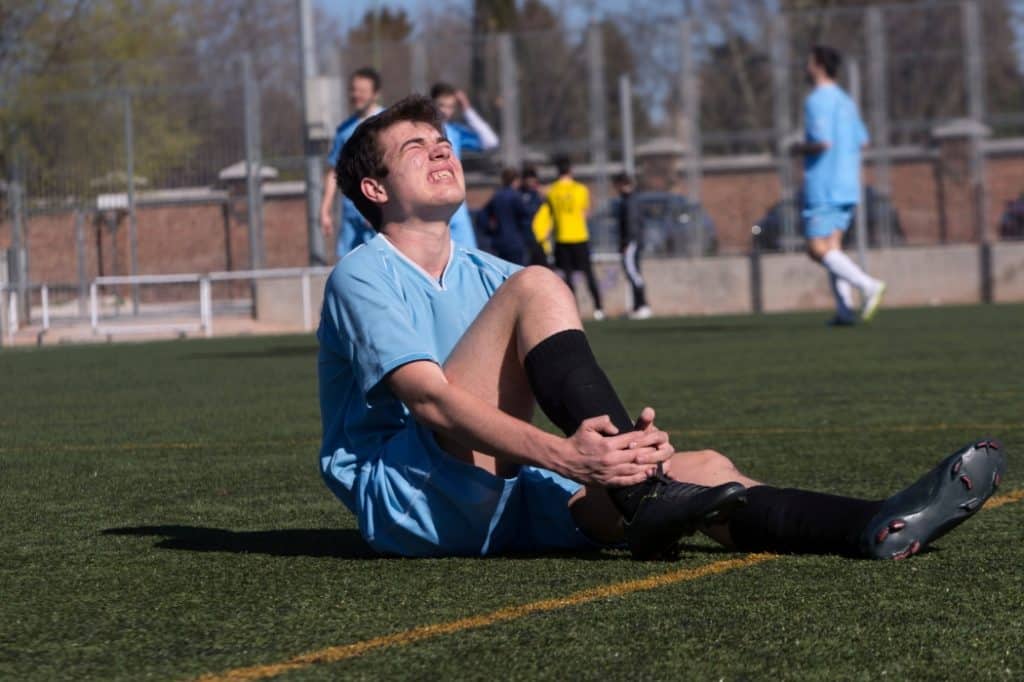 A man struggles with a soccer injury
