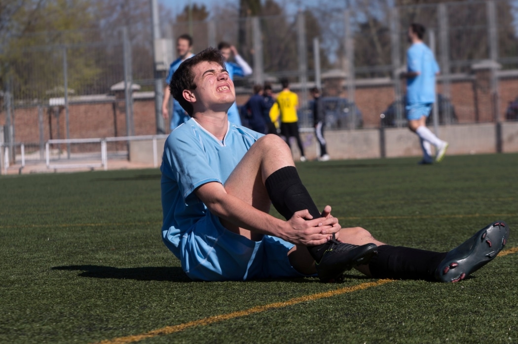 A man struggles with a soccer injury